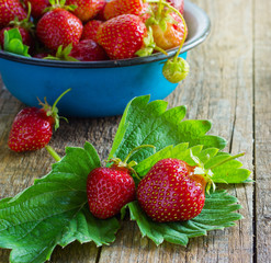 fresh juicy organic strawberries in an old metal bowl