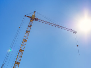 Construction crane against the blue sky