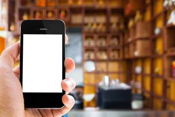 close up smart phone with blank screen against blur people in cafe background