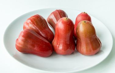 Rose apple on white dish
