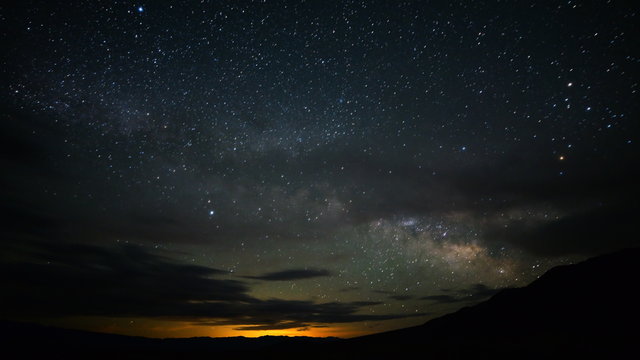  Astrophotography time lapse footage with tilt up motion of Milky Way galaxy rising over desert landscape in Death Valley National Park, California