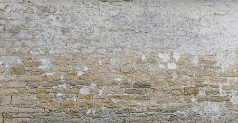 Background of old vintage  limestone wall with peeling plaster
