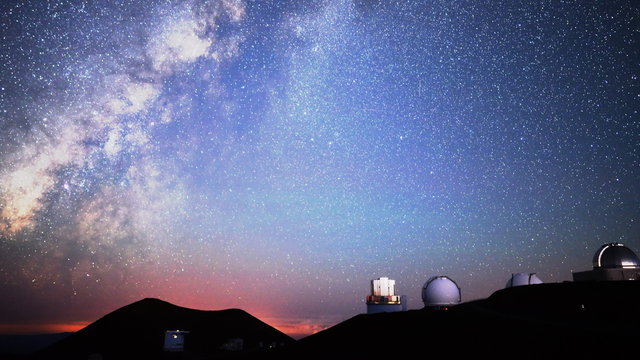  Astrophotography time lapse with pan right motion of milky way galaxy over Mauna Kea Observatories in Hawaii at dawn
