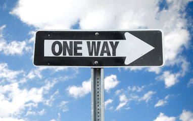 One Way direction sign with sky background