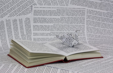 Origami dragon coming out of a book