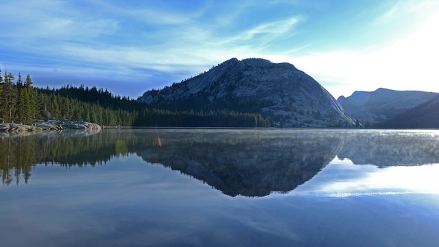  Time lapse footage with pan right motion of sunrise at reflective lake along Tioga Pass in Yosemite National Park, California