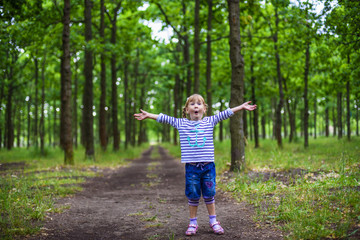 little happy girl playing in the park, baby laughing and having fun