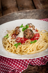 Spahetti with tomato sauce ,meatballs  and grated parmesan