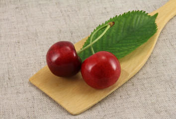 Abstract view cherry on wooden spatula