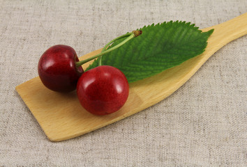 Abstract view cherry on wooden spatula