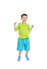 little boy in a t-shirt and shorts jumping