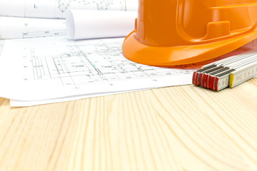 safety helmet and heap of project drawings