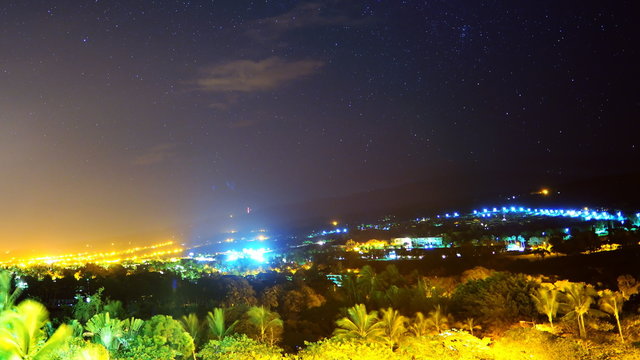  Astrophotography time lapse footage of startrails over city lights during sunrise in Kona, Hawaii