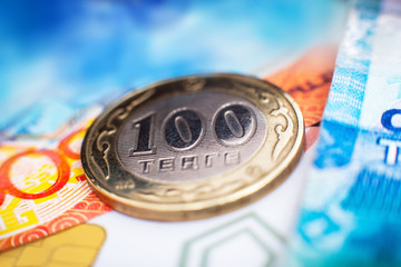 Kazakh tenge money/
/One hundred tenge lies at the center of a large pile of paper Kazakh money. With the money depict buildings and monuments of the Republic of Kazakhstan.
