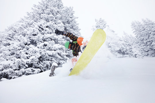Snowboarder jumping on ski slope