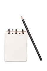 Closeup of book and pencil on white desk