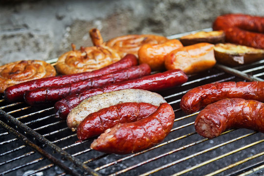Different grilled sausages and wurst on big grill.