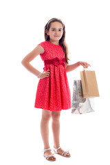 shopping concept - cute little girl with bags isolated on white background