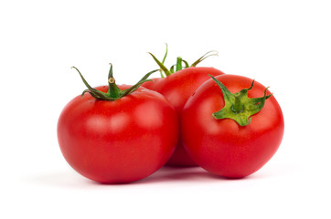 Fresh tomatoes with green leaves isolated on white background