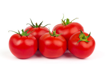 Fresh tomatoes with green leaves isolated on white background