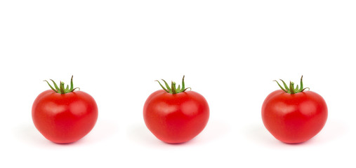 Fresh tomatoes with green leaves isolated on white background