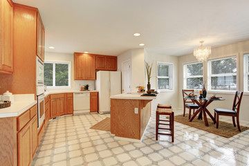 Complete kitchen with tile floor.