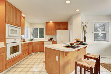 Complete kitchen with tile floor.