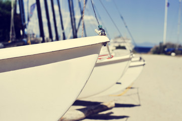 catamaran sailboats stranded in a beach, with a filter effect