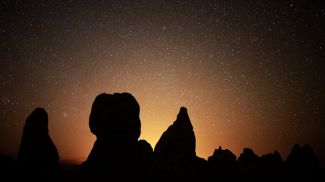  Astrophotography time lapse footage with tilt up motion of starry sky over monolithic formations in Trona Pinnacles, California