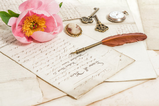 Old letters, pink peony flower and antique feather pen. Vintage