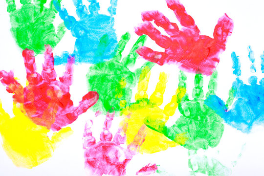Multicolored painted hand prints on a white background