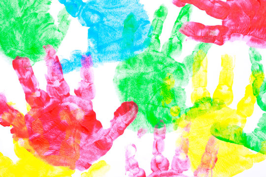 Multi colored painted hand prints on a white background.