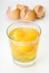 Raw Eggs in a Glass – A bunch of raw eggs, cracked into a glass.