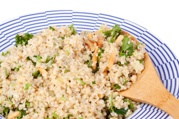 Tabbouleh Salad – A bowl of tabbouleh salad, with onions, parsley, and nuts.