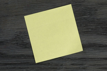 yellow sticky note on wooden table