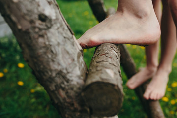 Girl climbing ladder into tree house