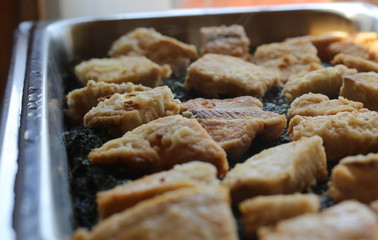 Many fish filets on a spinach bed