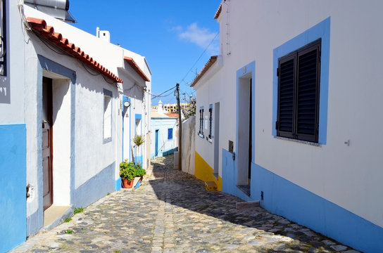 Quaint Ferragudo algarve cobbled street with houses