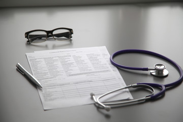 Stethoscope on the grey desk, close up