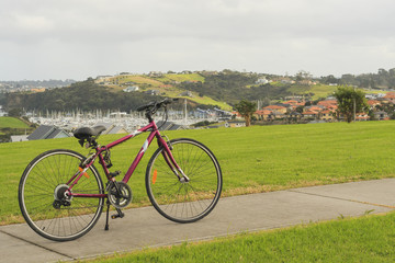 Fototapeta premium Bike overlooking the marina, Whangaparaoa, Auckland, New Zealand
