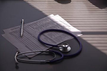 Stethoscope on the grey desk, close up