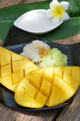 Thai style tropical dessert, glutinous rice eat with mangoes
