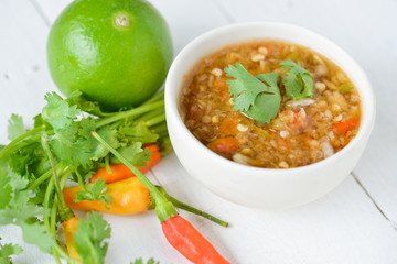 Spicy seafood dipping sauce for seafood on wood background