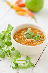 Spicy seafood dipping sauce for seafood on wood background