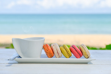 macaroon multicolored  with a cup of coffee