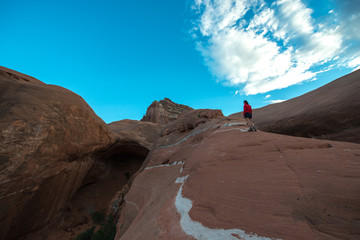 Woman walking on a slickrock Cave Point Escalante Utah