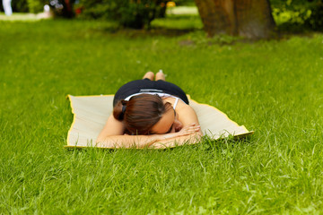 young woman relaxing on a grass