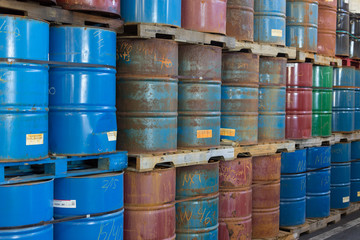 Rows of stacked steel barrels of various colors