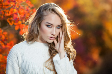 Fototapeta premium beautiful young woman with curly hair against a background of