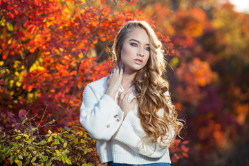 beautiful young woman with curly hair against a background of